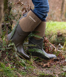 Walker in woods wearing Rockfish Wellington boots. Walkers wellies are Groundhog.